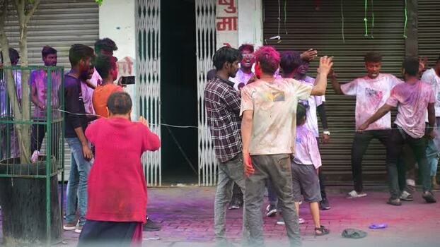 View of people celebrating Holi festival with colorful powder Nepal.