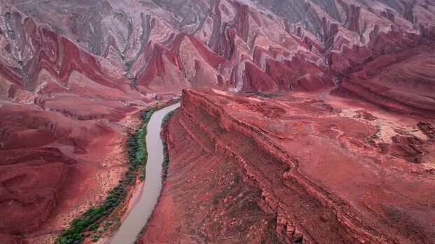 Aerial view of the Colorado River winding through red canyons United States.