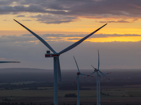 Aerial view of wind turbines at Sieversdorf Windpark during golden hour with a rural landscape in the background in Jacobsdorf Brandenburg Germany. Aerial view of wind turbines at Sieversdorf Windpark during golden hour with a rural landscape in the background in Jacobsdorf Brandenburg Germany.