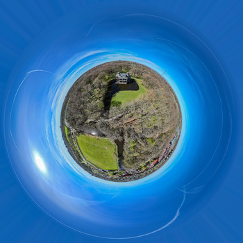 Aerial view of a vibrant green park and winding river contrasting with the surrounding dense forest at Landgoed Oud Poelgeest Oegstgeest Zuid Holland Netherlands. Aerial view of a vibrant green park and winding river contrasting with the surrounding dense forest at Landgoed Oud Poelgeest Oegstgeest Zuid Holland Netherlands.