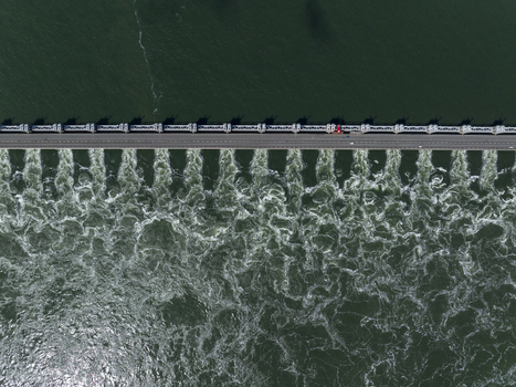 Aerial view of the Eastern Scheldt Storm Surge Barrier with turbulent water flowing through the sluice gates in Vrouwenpolder Zeeland Netherlands. Aerial view of the Eastern Scheldt Storm Surge Barrier with turbulent water flowing through the sluice gates in Vrouwenpolder Zeeland Netherlands.