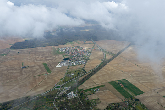 Aerial view of a strategic landscape unfolds where the meticulously planned fortress city meets the embrace of open fields and winding roads Neuf Brisach Grand Est France.