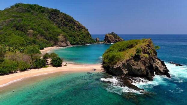 Aerial view of Koka Beach with turquoise water and rocky cliffs Indonesia. Aerial view of Koka Beach with turquoise water and rocky cliffs Indonesia.