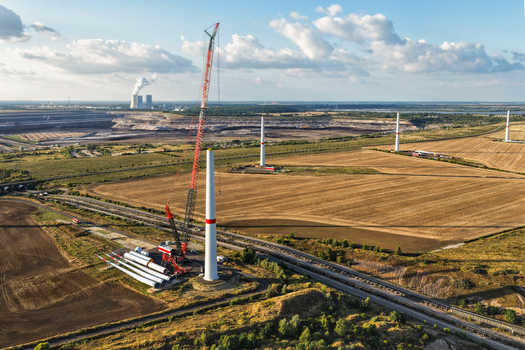 Aerial view of the construction of wind turbines with a large crane and turbine components at the lignite open cast mine Schleenhain in Zwenkau Saxony Germany.