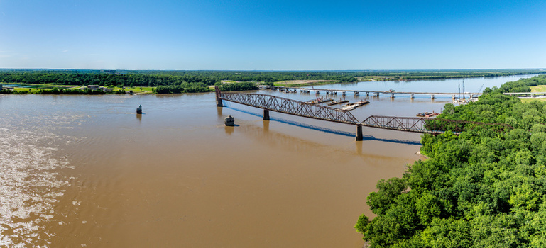 View of the historic Old Chain of Rocks Bridge spanning the Mississippi River with lush green riverbanks in St. Louis Missouri United States. View of the historic Old Chain of Rocks Bridge spanning the Mississippi River with lush green riverbanks in St. Louis Missouri United States.