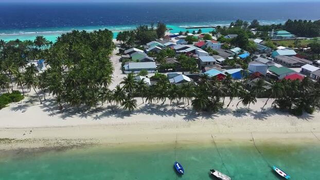 Aerial view of a tropical island village in Maldives. Aerial view of a tropical island village in Maldives.