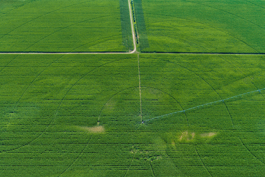 Aerial view of a circular irrigation system in a lush green agricultural field with crop rows and a central pivot sprinkler in Hombourg Grand Est France. Aerial view of a circular irrigation system in a lush green agricultural field with crop rows and a central pivot sprinkler in Hombourg Grand Est France.