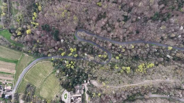 Aerial view of winding road through forest France.