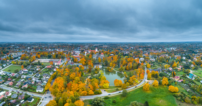 Aerial view of Cesis Castle ruins surrounded by vibrant autumn foliage a park with a pond and residential buildings in Cesis Cesis Municipality Latvia. Aerial view of Cesis Castle ruins surrounded by vibrant autumn foliage a park with a pond and residential buildings in Cesis Cesis Municipality Latvia.