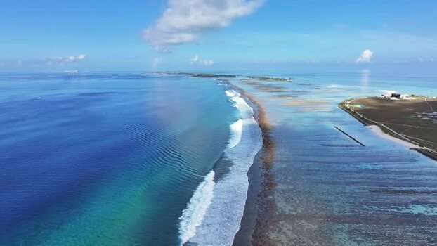 Aerial view of waves breaking on the reef at Thulusdhoo Maldives.