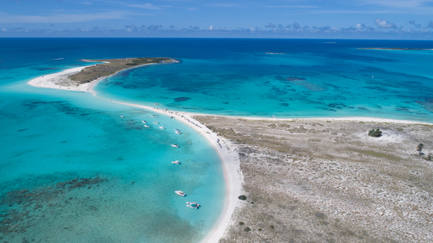 Aerial view of Los Roques archipelago with turquoise waters white sandbars and small boats anchored in the Caribbean Sea Los Roques Dependencias Federales Venezuela. Aerial view of Los Roques archipelago with turquoise waters white sandbars and small boats anchored in the Caribbean Sea Los Roques Dependencias Federales Venezuela.