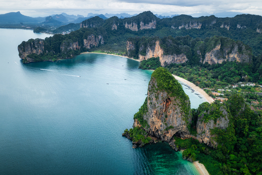 Aerial view of Railay Beach with its iconic limestone cliffs turquoise waters and lush greenery in Ao Nang Krabi Thailand. Aerial view of Railay Beach with its iconic limestone cliffs turquoise waters and lush greenery in Ao Nang Krabi Thailand.