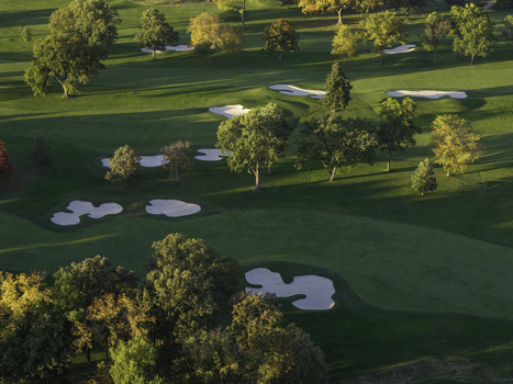 Aerial view of a golf course in autumn with vibrant fall foliage sand bunkers and manicured green fairways in Glenview Illinois United States. Aerial view of a golf course in autumn with vibrant fall foliage sand bunkers and manicured green fairways in Glenview Illinois United States.