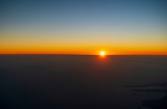 Aerial view of a vibrant sunset over the horizon with the coastline of Karachi Sindh Pakistan.