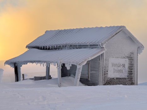 View of an ice encrusted cabin a frozen sentinel against the backdrop of a pale dawn its weathered facade whispering tales of winter s embrace Covilh&atilde; Portugal.