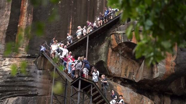 View of tourists climbing the stairs of Sigiriya rock Sri Lanka.