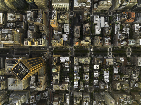 Aerial view of Manhattan in New York featuring a dense grid of skyscrapers rooftops and city streets in New York New York United States. Aerial view of Manhattan in New York featuring a dense grid of skyscrapers rooftops and city streets in New York New York United States.