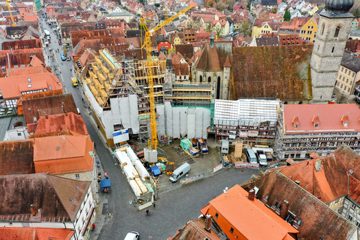 Aerial view of Rathaus Forchheim under renovation with a yellow crane and scaffolding among historic red tiled rooftops Forchheim Bayern Germany. Aerial view of Rathaus Forchheim under renovation with a yellow crane and scaffolding among historic red tiled rooftops Forchheim Bayern Germany.