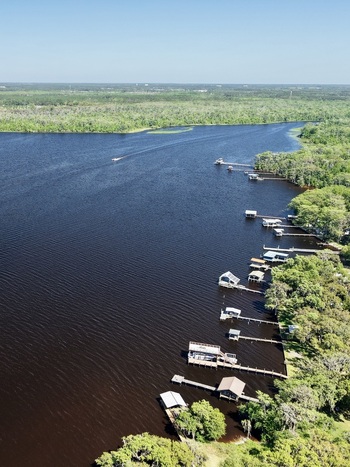 Aerial view of dark waters reflecting the sky lined with docks and boats nestled amongst the vibrant green trees St. Augustine Florida United States. Aerial view of dark waters reflecting the sky lined with docks and boats nestled amongst the vibrant green trees St. Augustine Florida United States.