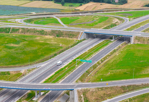 Aerial view of a highway interchange with green fields and a bridge in Gdansk Pomeranian Voivodeship Poland. Aerial view of a highway interchange with green fields and a bridge in Gdansk Pomeranian Voivodeship Poland.