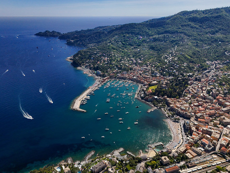 Aerial view of the harbor and colorful buildings along the waterfront with boats moored in the blue bay and lush green hills Santa Margherita Ligure Liguria Italy. Aerial view of the harbor and colorful buildings along the waterfront with boats moored in the blue bay and lush green hills Santa Margherita Ligure Liguria Italy.