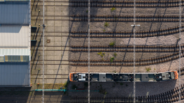 Aerial view of the Rhein Neckar Verkehr GmbH tram depot with a tram parked on the tracks next to the maintenance facility in Ludwigshafen am Rhein Rheinland Pfalz Germany. Aerial view of the Rhein Neckar Verkehr GmbH tram depot with a tram parked on the tracks next to the maintenance facility in Ludwigshafen am Rhein Rheinland Pfalz Germany.