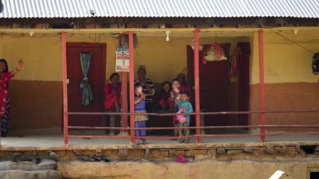 View of people waving from a house porch in Dhangadhi Nepal. View of people waving from a house porch in Dhangadhi Nepal.