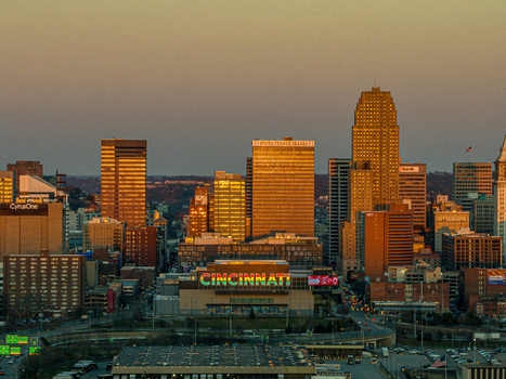 Aerial view of the Cincinnati skyline illuminated by the setting sun with the Heritage Bank Center standing prominently Cincinnati Ohio United States. Aerial view of the Cincinnati skyline illuminated by the setting sun with the Heritage Bank Center standing prominently Cincinnati Ohio United States.