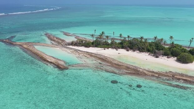 Aerial view of a tropical island and coral reefs Maldives.