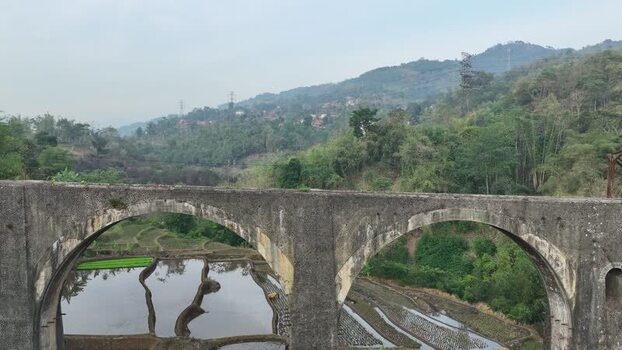 Aerial view of stone bridge over rice terraces in Indonesia. Aerial view of stone bridge over rice terraces in Indonesia.