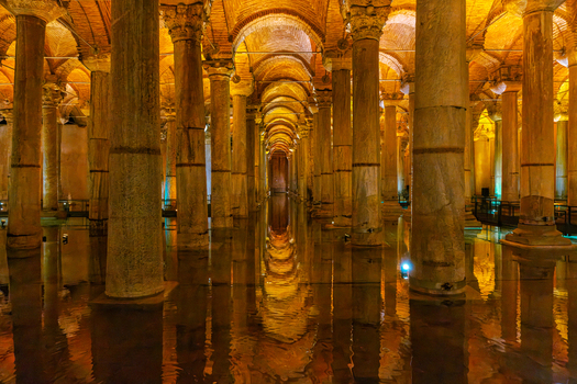 Fatih Turkiye 26 July 2026 View of the Basilica Cistern with its rows of ancient marble columns reflected in the calm water under warm golden lighting.