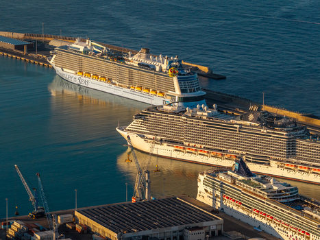 Civitavecchia Italy 23 August 2026 Aerial view of Civitavecchia Port with large cruise ships docked at the harbor featuring industrial cranes and calm water under golden hour light.