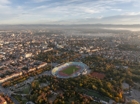 Aerial view of Vasil Levski National Stadium surrounded by lush trees and the urban landscape of Sofia Sofia City Province Bulgaria. Aerial view of Vasil Levski National Stadium surrounded by lush trees and the urban landscape of Sofia Sofia City Province Bulgaria.