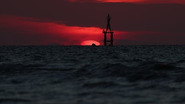 View of a navigational beacon at sunset France.