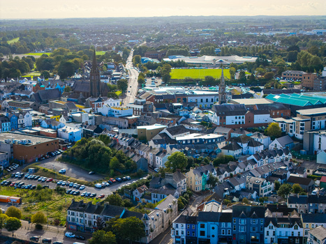 Aerial view of Bangor Harbour and Town featuring historic church spires dense residential rooftops and commercial buildings in Bangor Northern Ireland United Kingdom.