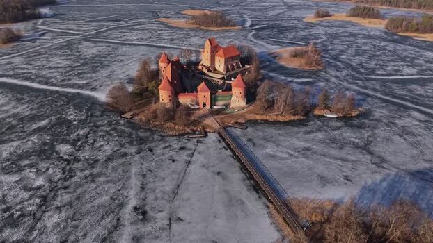 Aerial view of Trakai Castle on frozen lake Lithuania.