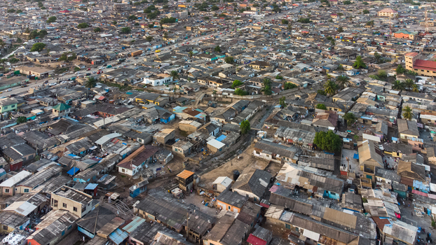 Aerial view of the dense urban neighborhood of Teshie with corrugated metal rooftops and narrow streets in Accra Greater Accra Region Ghana.