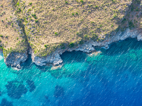Aerial view of the rugged coastline of Riserva Naturale Orientata dello Zingaro with turquoise Mediterranean waters and rocky cliffs in San Vito Lo Capo Sicilia Italy. Aerial view of the rugged coastline of Riserva Naturale Orientata dello Zingaro with turquoise Mediterranean waters and rocky cliffs in San Vito Lo Capo Sicilia Italy.