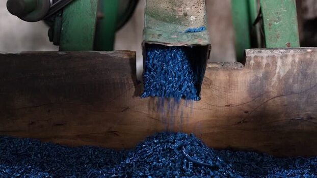 View of blue plastic pellets falling from a chute Bangladesh. View of blue plastic pellets falling from a chute Bangladesh.