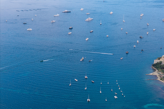Aerial view of numerous yachts and boats anchored near the coast of Ile Sainte Marguerite in the Mediterranean Sea Cannes Provence Alpes Cote d Azur France. Aerial view of numerous yachts and boats anchored near the coast of Ile Sainte Marguerite in the Mediterranean Sea Cannes Provence Alpes Cote d Azur France.