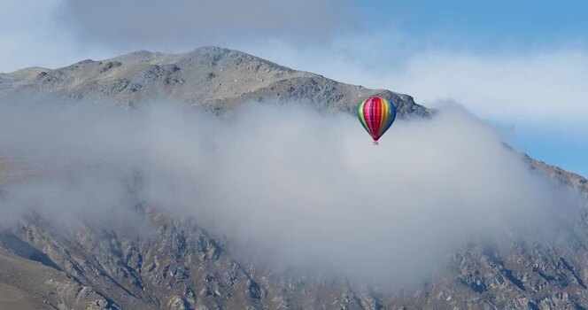View of hot air balloon and cloudy mountain New Zealand.