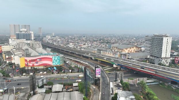Aerial view of the urban landscape featuring the Metropolitan Mall elevated highway infrastructure and surrounding buildings in Bekasi Barat West Java Indonesia. Aerial view of the urban landscape featuring the Metropolitan Mall elevated highway infrastructure and surrounding buildings in Bekasi Barat West Java Indonesia.