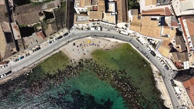 Aerial view of the rocky coast and beach in Syracuse Italy.