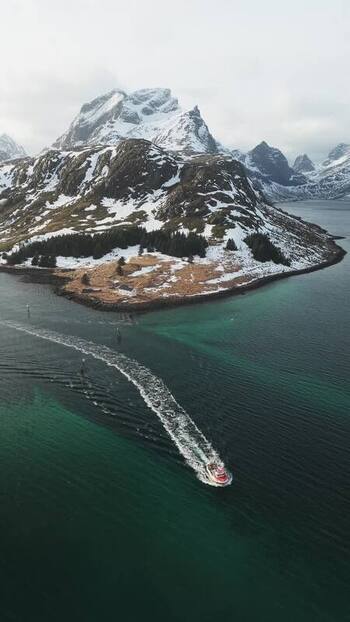 Aerial view of M&oslash;lnarodden and boat wake Norway.