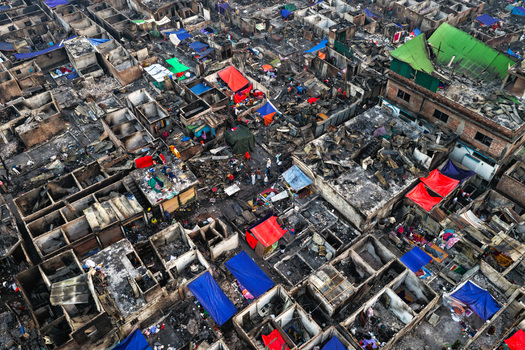 Aerial view of the aftermath of a fire at Korail Basti showing destroyed structures debris and makeshift shelters in Dhaka Dhaka Division Bangladesh.