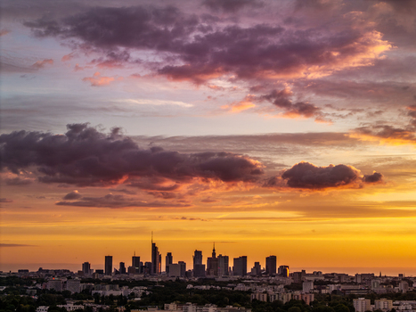 Aerial view of the Warsaw city skyline and the Palace of Culture and Science under a dramatic sunset sky with colorful clouds Poland. Aerial view of the Warsaw city skyline and the Palace of Culture and Science under a dramatic sunset sky with colorful clouds Poland.
