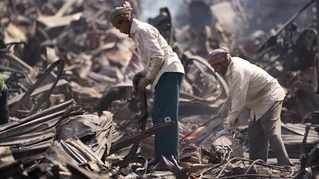View of workers sorting through metal scrap in a junkyard Bangladesh. View of workers sorting through metal scrap in a junkyard Bangladesh.