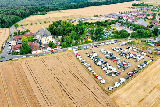 Eggolsheim Germany 09 May 2026 Aerial view of Schloss Jagersburg surrounded by historic buildings agricultural fields and a large parking area filled with cars and campers. Eggolsheim Germany 09 May 2026 Aerial view of Schloss Jagersburg surrounded by historic buildings agricultural fields and a large parking area filled with cars and campers.