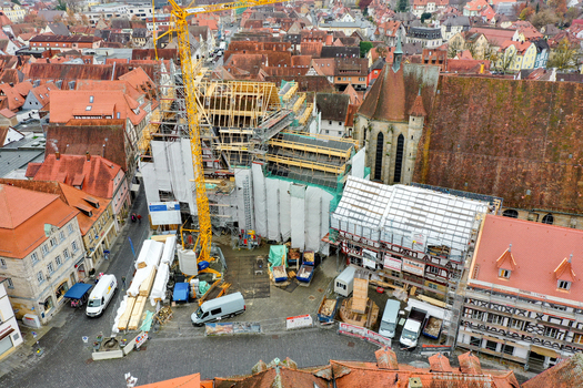 Aerial view of Rathaus Forchheim under renovation with a yellow crane scaffolding and historic red tiled rooftops in Forchheim Bayern Germany. Aerial view of Rathaus Forchheim under renovation with a yellow crane scaffolding and historic red tiled rooftops in Forchheim Bayern Germany.