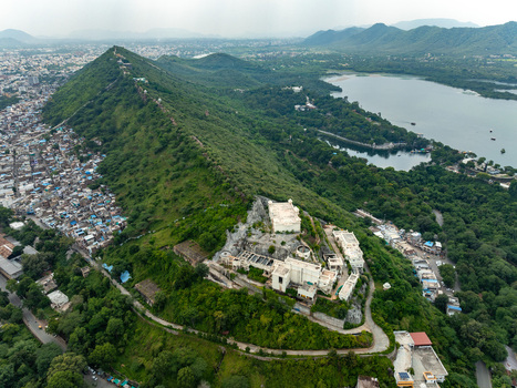 Aerial view of Sajjangarh Monsoon Palace on a hilltop overlooking Udaipur surrounded by lush forests and Fateh Sagar Lake Udaipur Rajasthan India. Aerial view of Sajjangarh Monsoon Palace on a hilltop overlooking Udaipur surrounded by lush forests and Fateh Sagar Lake Udaipur Rajasthan India.